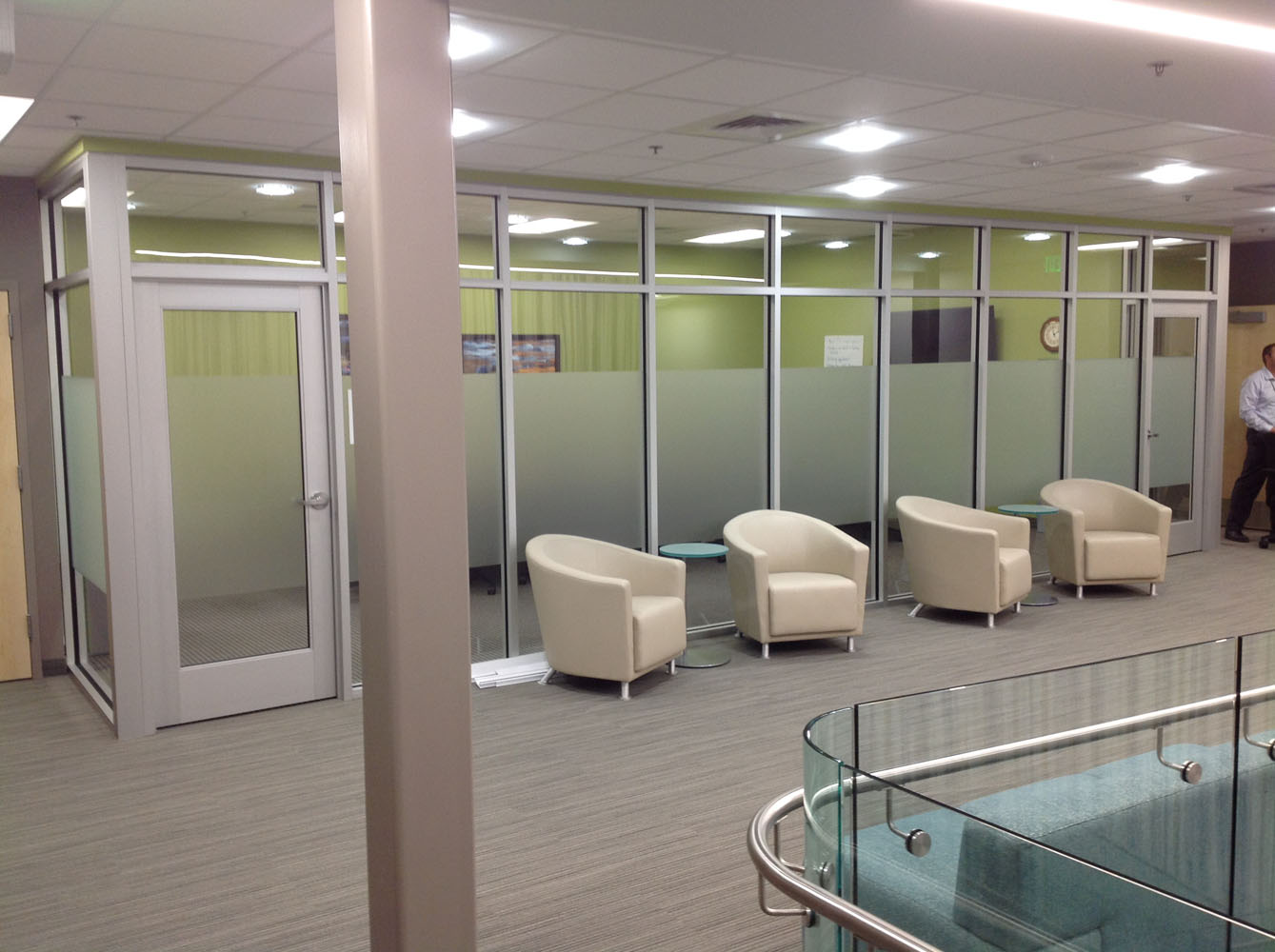 A long row of offices with frosted windows.